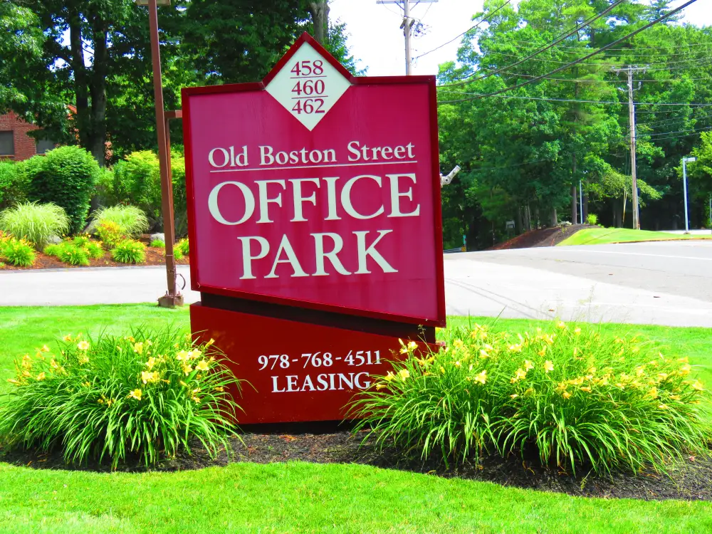 Old Boston Street Office Park sign beside the street.